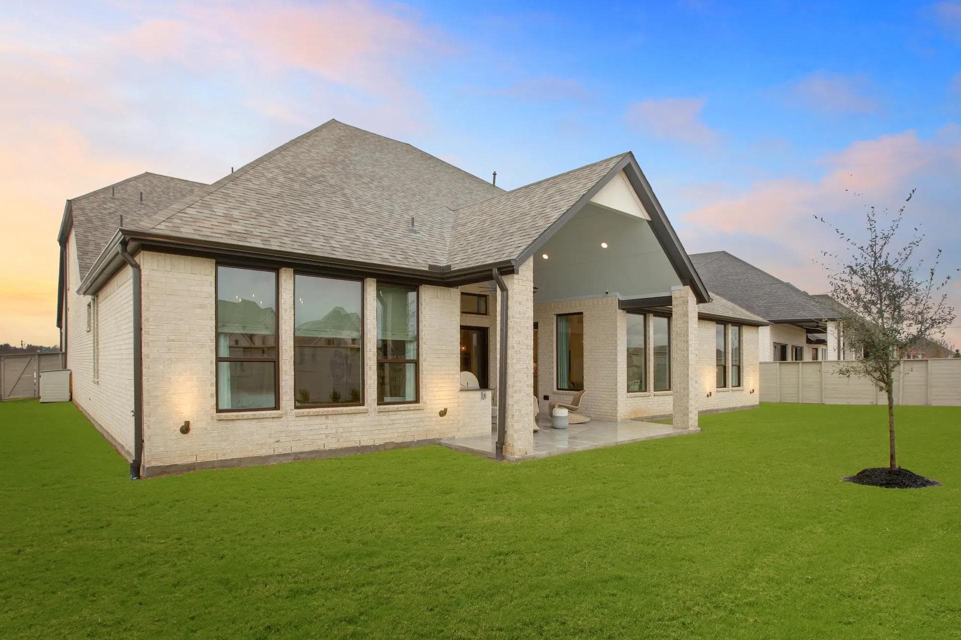 Rear exterior with a fenced backyard and covered porch