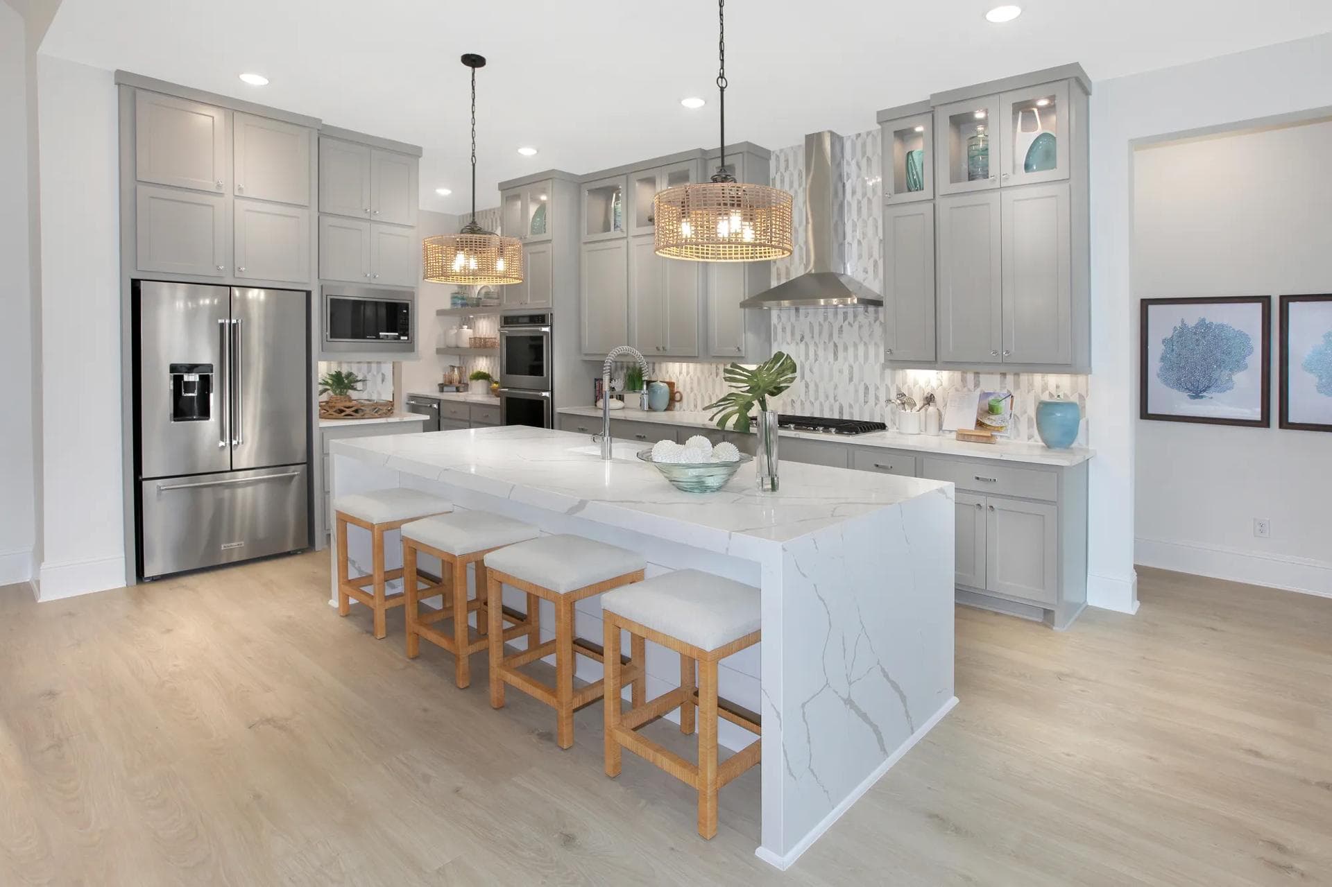 Kitchen with gray cabinetry and a waterfall island